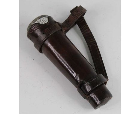 An early 20th century hunting flask, having a conical glass body with silver plated bayonet cap, housed in a brown leather ca