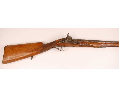 A 19th century percussion rifle (flintlock conversion), having a 72cm barrel, the walnut stock later carved with a hunting sc