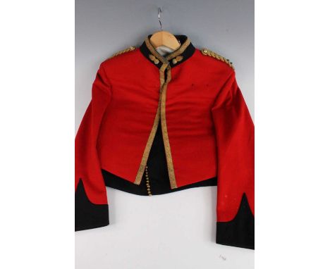 An Officer's mess jacket having gold braid epaulettes with flaming grenade collar badges and parachute wings badge to the rig