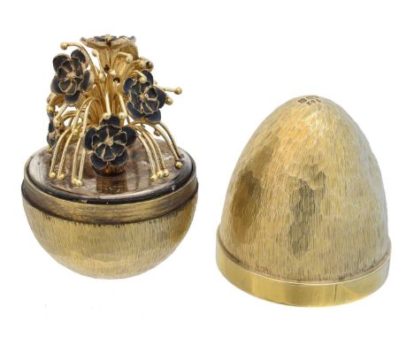 A silver gilt and enamel 'surprise egg' by Stuart Devlin, the textured and planished silver gilt egg opening to reveal a blue