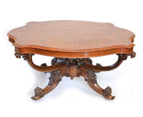 Victorian walnut centre table, the top with matched quartered veneers, serpentine wavy edge, all supported on four swept legs