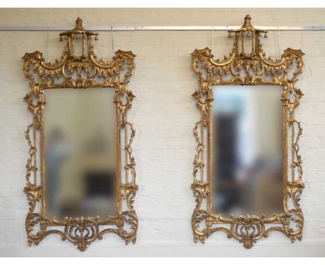 A pair of Chippendale style rococo and icicle design gesso framed wall mirrors, each with pagoda pediment decorated with bell