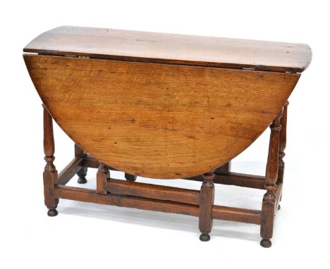 18th-century oak drop-leaf dining table, the oval top with two leaves supported on gate-leg base with turned columns, square 