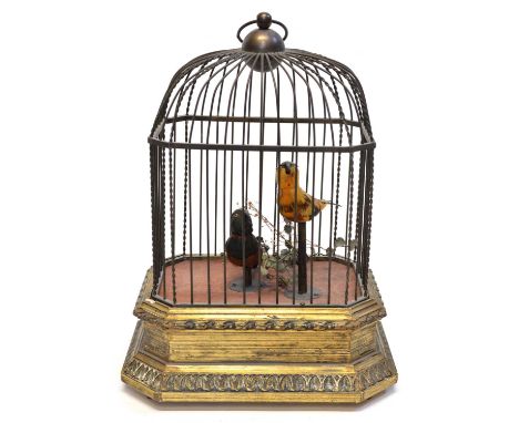 Early 20th Century Singing birdcage automaton with two birds inside a domed brass cage on a gilt wooden and plaster base. The