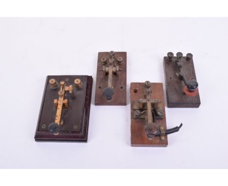 Four early 20th century Morse keys,Unmarked, one with ebonite panel in mahogany base; and three all-wood bases with brass fit