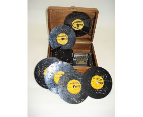 A 4.1/2-inch Thorens disc musical box,Late 20th century, with captive key-wind motor, single comb, machined blued movement in
