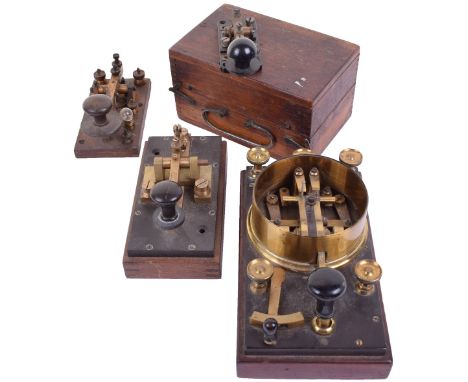 Four late 19th century Morse keys,Unmarked, large example with change-over switch and five taps; wooden base with bulb holder