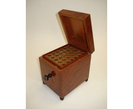 A yew wood veneered musical cigarette caddy,Mid 20th century, With central ebonised start/stop twist for single air, hinged l
