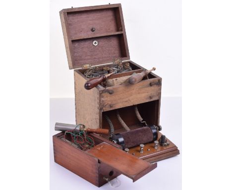 Two small induction electricity machines,Early 20th century,First with pull-down coil, twin wooden grip prods, twin batteries