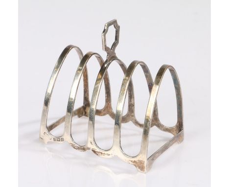 Elizabeth II silver toast rack, Birmingham 1964, maker Henry Clifford Davis, with pierced finial above four arched divisions,