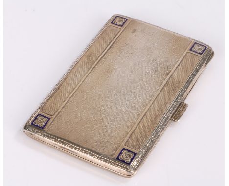 Early 20th Century continental silver cigarette case, the engine turned exterior with blue enamel corners, the gilt interior 