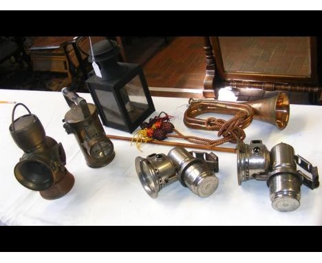 An assortment of lamps including a brass Ceag miners inspection lamp, together with military bugle and swagger stick 