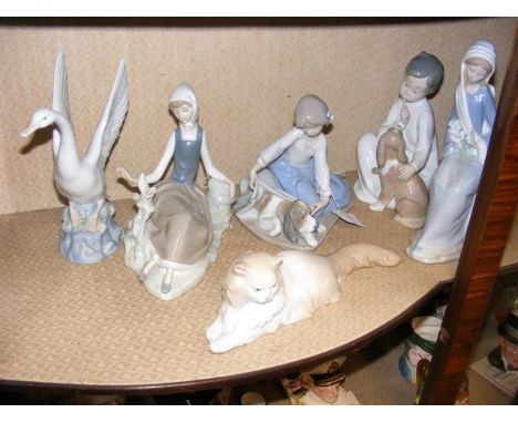 Four Lladro figures including a boy with dog, together with two Nao figures