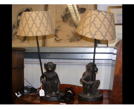 A pair of resin bronze style 'monkey' table lamps