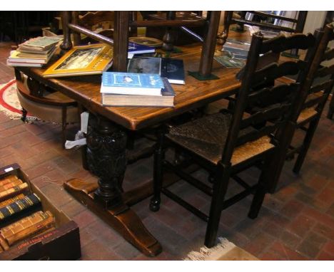 A carved oak refectory table on bulbous supports with stretcher, together with a set of six ladder back chairs with rush seat