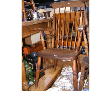 A Windsor stick back arm chair, missing one stretcher