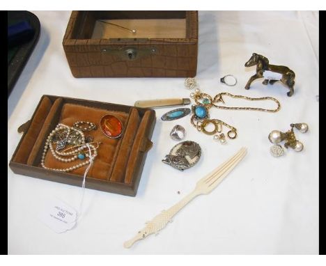 A pearl necklace, brooches, etc. 