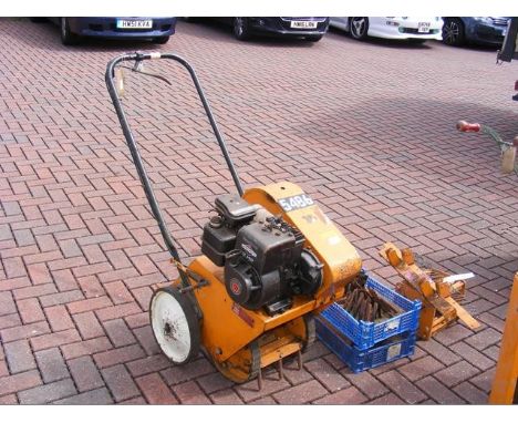 A petrol driven turf slitter with tools
