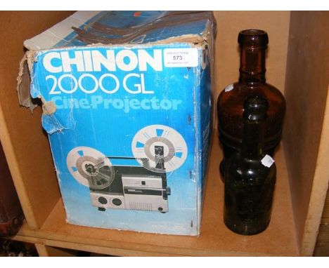 Two vintage bottles together with a Chinon Cine-projector with reels