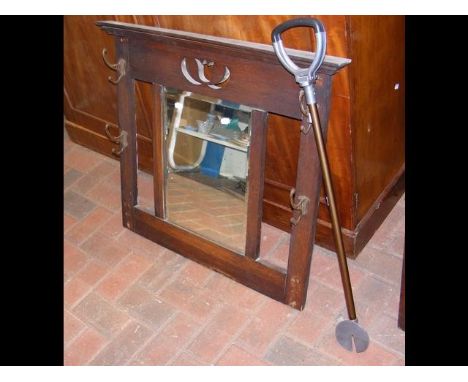 An Art Nouveau oak hall coat rack with centre mirror, together with a shooting stick