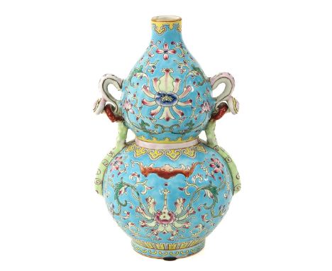 Light blue ground decorated with bats and flowers, the handles ruyi shaped, Qianlong mark, 22 cm. tall, the ring on one handl