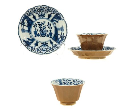 Depicting Chinese antiquities, saucers are 12 cm. in diameter, Kangxi mark, chip and hairline.