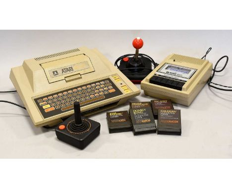 Atari 400 Computer in original box, with five game cartridges: Star Raiders, Donkey Kong, Missile Command, Pac-Man and Galaxi