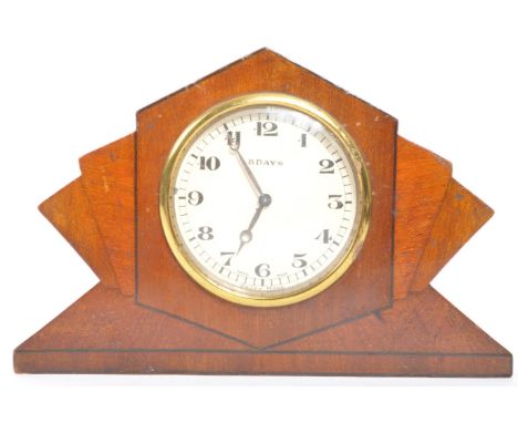 An 1920’s Art Deco walnut sunburst 8 day mantel clock. The clock having a white dial with Arabic numerals to the chapter ring