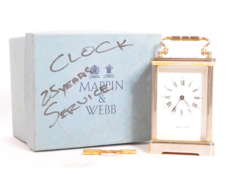 A Mappin &amp; Webb English repeating carriage clock. With white metal carry handle to top, viewing window to top with rectan