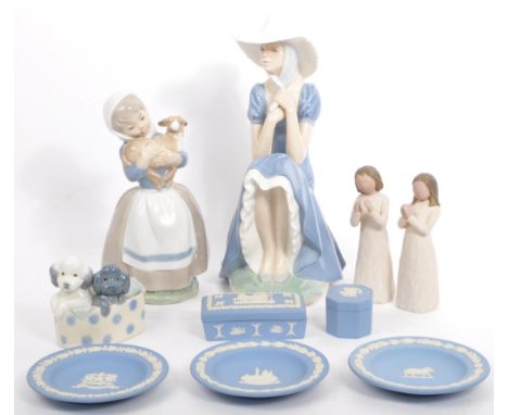 A collection of three late 20th century Spanish Lladro Nao porcelain china figurines. One depicting a young girl holding a la