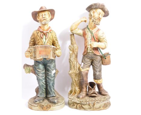 Two vintage 20th century Capodimonte style ceramic figurines. Depicting a gentleman playing an accordion sat on a tree, with 