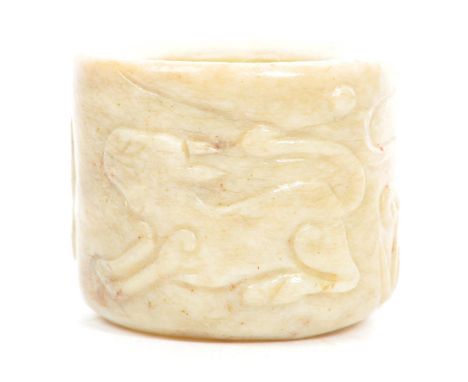 A 19th century, possibly 18th century, jade archers finger band, of mottled beige colourway. With carved animal and dragon de