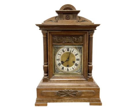 Juhngans-Late 19th century German walnut cased 8-day Westminster chiming mantle clock in a decorative case with a carved pedi