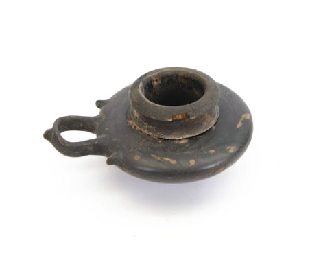 Etruscan terracotta oil lamp, with black glaze, flat loop handle and laurel leaf border, the opening with later turned wooden