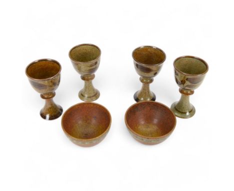 David Lloyd Jones (1928-1994): set of four studio pottery goblets, with foliate decoration on a mottled brown ground, togethe