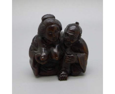 An ironwood man with geisha netsuke 