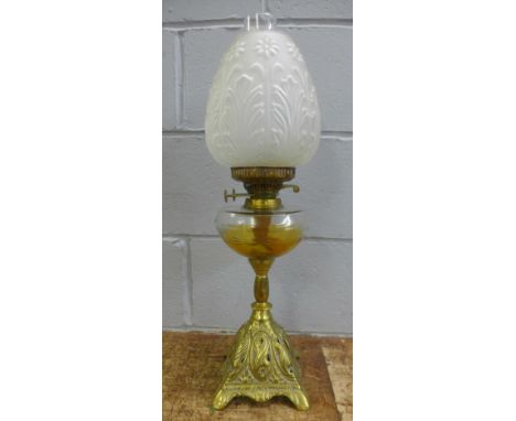A brass and glass oil lamp with frosted glass shade 