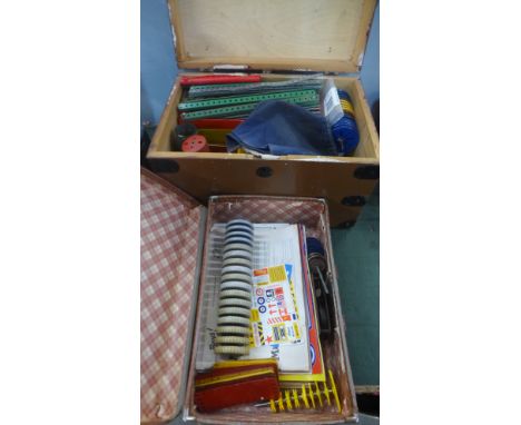 A collection of Meccano in a trunk with wheels, motors, model booklets and stickers 
