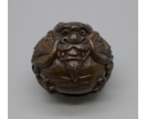 A spherical ironwood dragon netsuke 