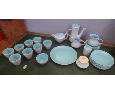 A Poole Pottery tea set, eight setting plus large plate, teapot, coffee pot, two milk jugs, sugar bowl and two preserve pots 