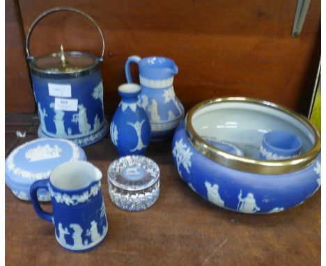Eleven items of Wedgwood light and dark blue jasperware; biscuit barrel, bowl with plated rim, two jugs, paperweight, etc. 