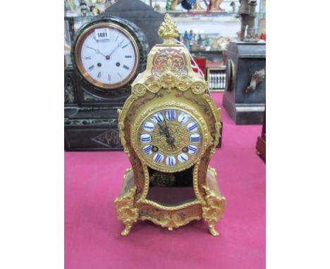 A French Boulle Early XX Century Mantel Clock, of Rococco form with brass overlay on tortoiseshell, the circular dial with en
