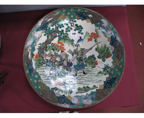 A Late XIX Century Japanese Circular Pottery Charger, decorated in the famille verte palette with figures, one with a bow and