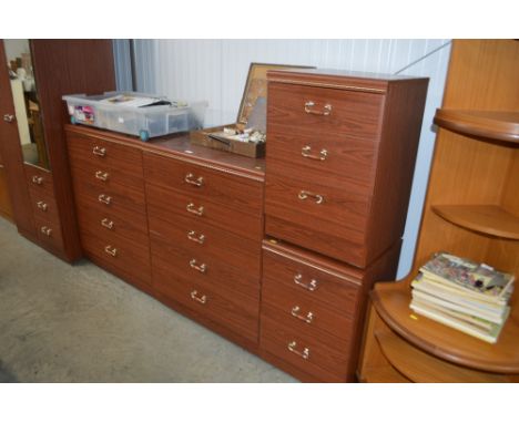 A bedroom suite comprising of a mirror fronted wardrobe fitted three drawers; a pair of modern chests fitted four drawers and