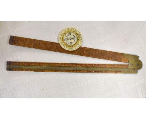 A 19th century folding boxwood carpenter's slide-rule with brass hinge, slide and end-caps, printed by stress and load tables