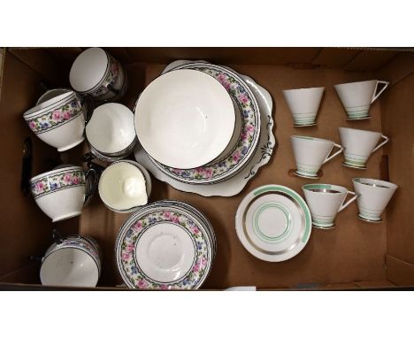 A Taylor &amp; Kent Art Deco china part tea service printed with bands of roses for twelve (missing one plate and teapot) to/