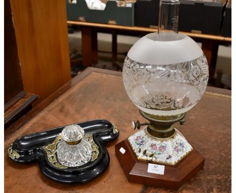 A Victorian black lacquer and brass moulded ink stand with lidded glass bottle to/w porcelain and brass floral painted oil la