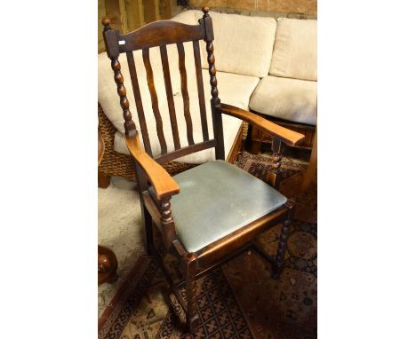 Five early 20th century oak slat back dining chairs with charcoal dralon seats and bobbin turned supports, (4 + 1 carver)