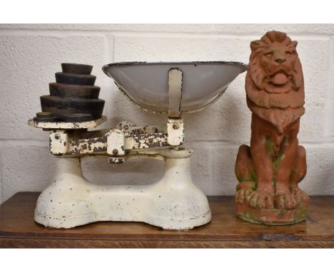 A terracotta seated lion figure 32 cm to/w vintage scales and weights