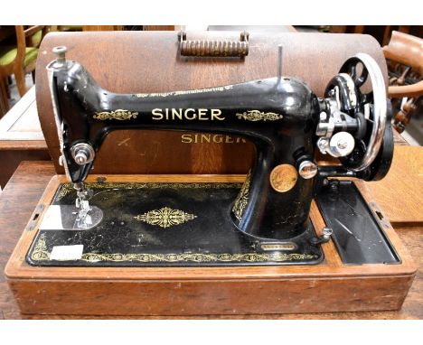 A vintage black and gilt Singer sewing machine with original domed bentwood case and key (no Y9481111, made in New Jersey 193